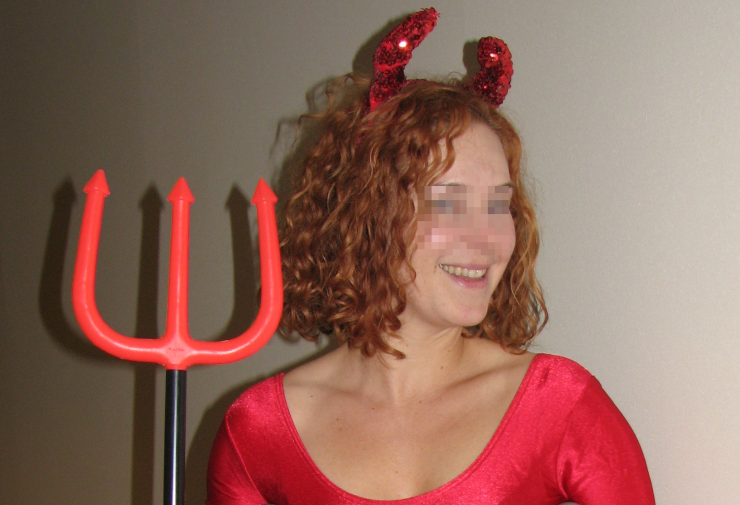 A woman dressed in a devil costume