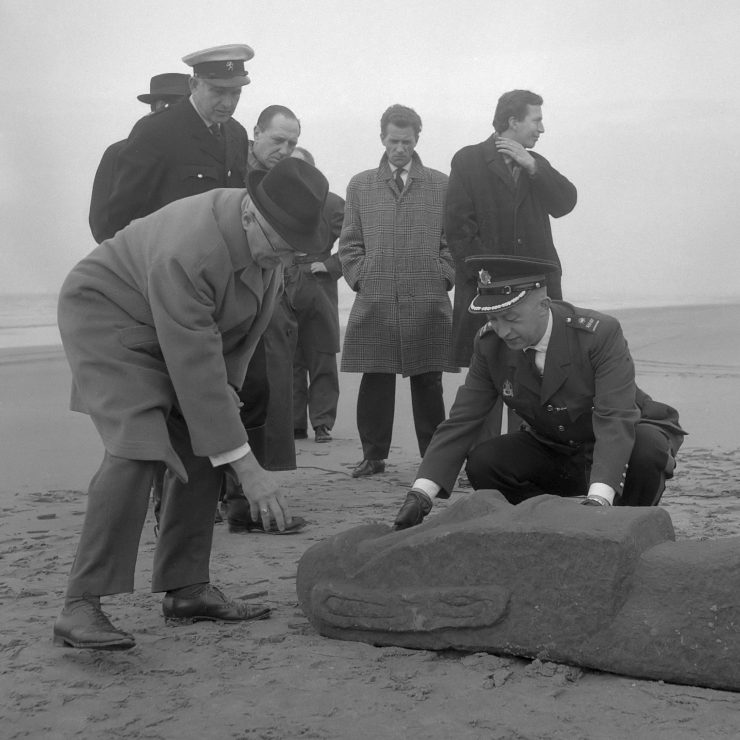 Dutch officials pretending that a Moai statue washed up on shore