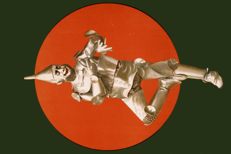 A person dressed as Baum's Tin Woodman, against a red disc