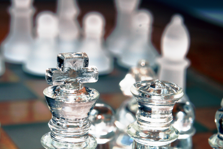 A close-up of a glass chess set