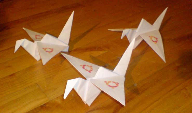 Paper cranes made from paper with the old Ubuntu logo on it
