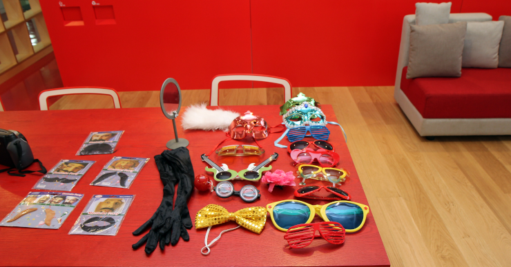 A table at a party with paste-on facial hair and novelty glasses