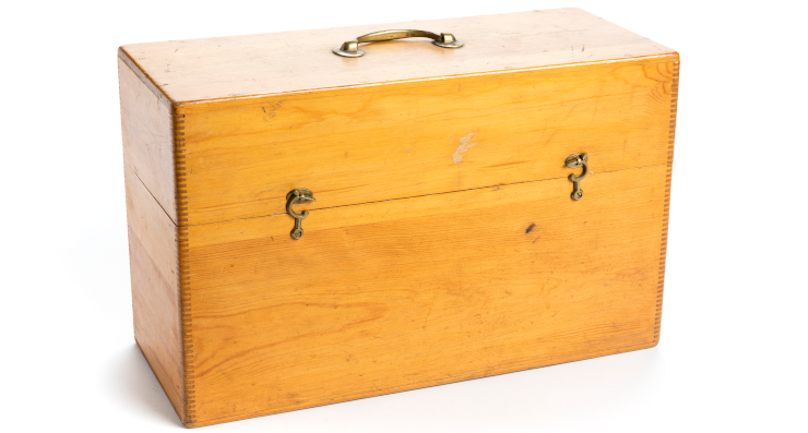 A wooden box with a metal handle and latches