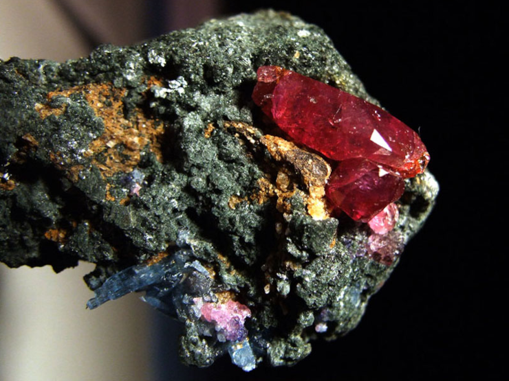 An uncut ruby in a larger stone