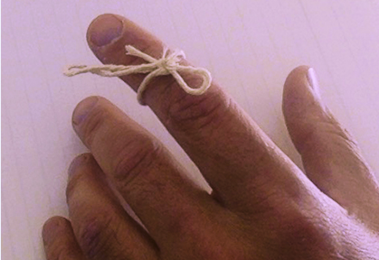 A length of string tied around an index finger