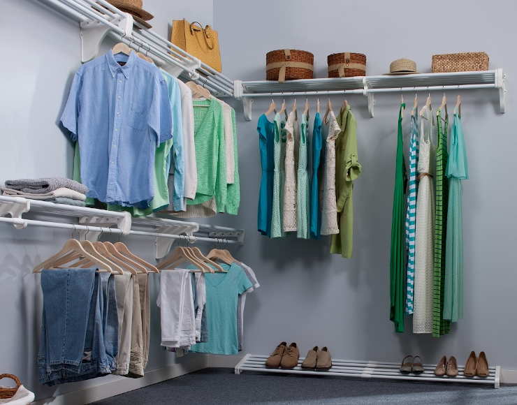 A walk-in closet with clothes hanging
