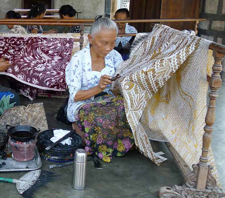 A craftsperson dying batik