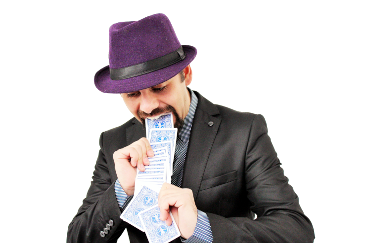 An amateur magician appearing to pull a series of playing cards out of his mouth