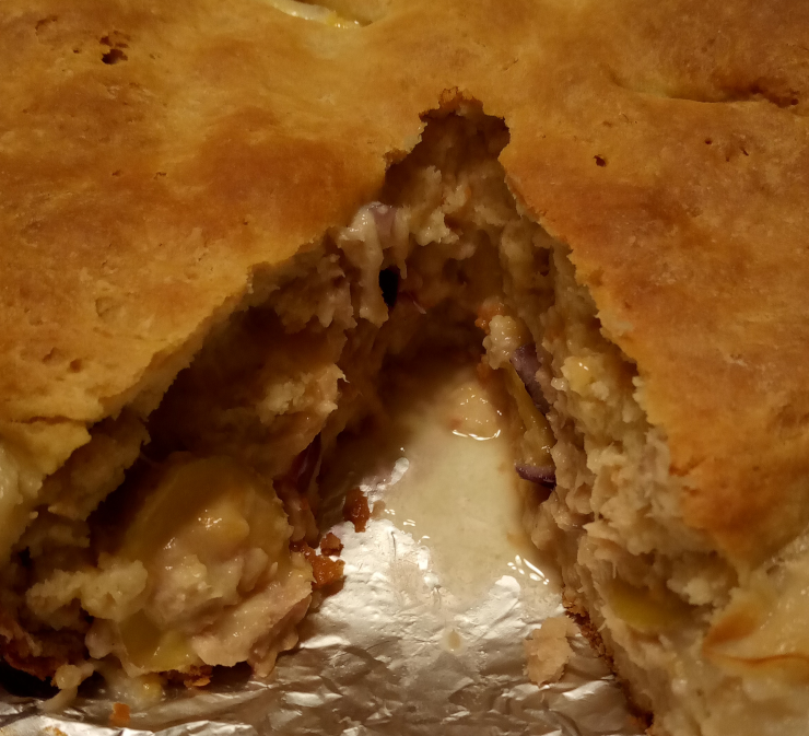 The salmon-and-potato pie with the first slice removed