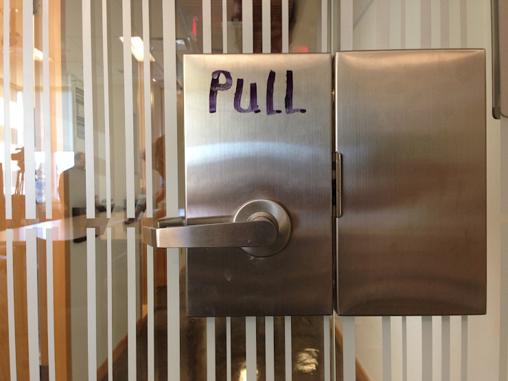 A door labeled Pull, in marker